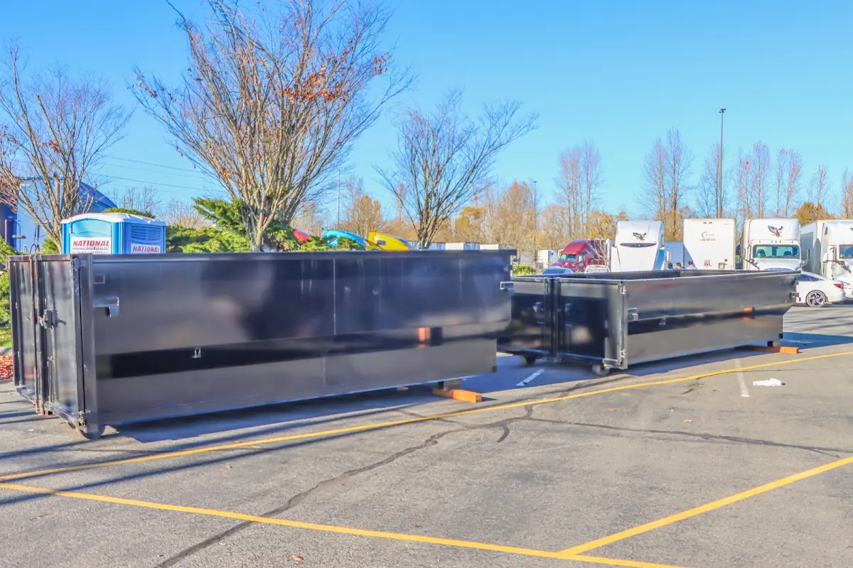 Professional dumpster rental service with roll-off container on residential driveway in Denham Springs